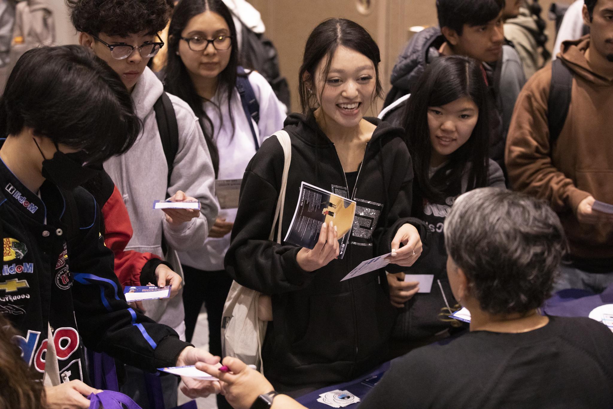 Students talking to staff and faculty during National First-Generation College Student Week.